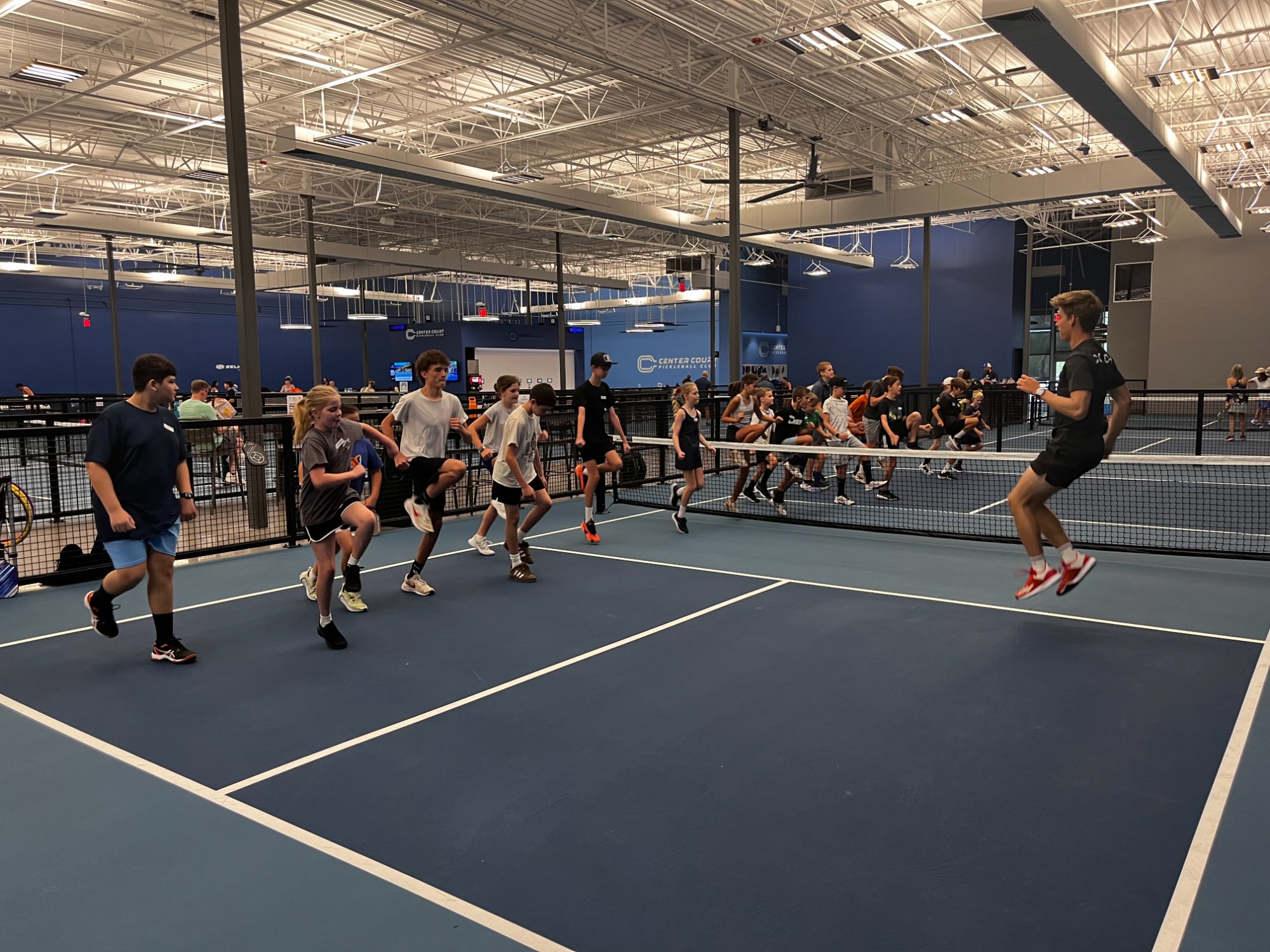 Kids running drills on court